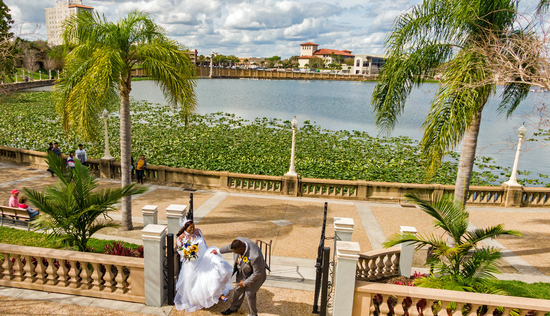 A drone-captured image of a wedding by a scenic lake, showcasing Tampa Bay Drone Image LLC’s event photography